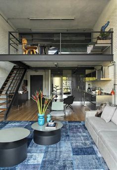 a living room filled with furniture and a stair case