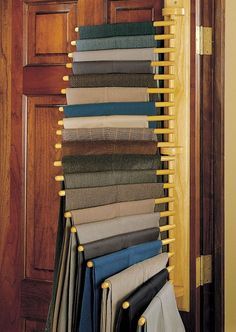 a rack that has many different colored fabrics on it