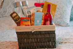 a basket filled with food on top of a bed