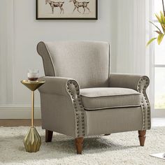 a living room with a chair and side table