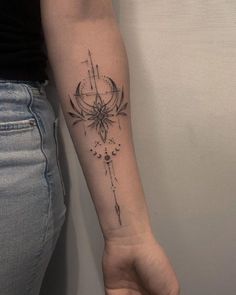 a woman's arm with a compass tattoo on it