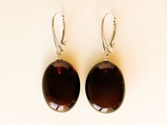 "Natural Baltic amber medium size dark cherry color oval earrings - suitable for both everyday wear and special occasion. These genuine handmade amber earrings are made with sterling silver 925 closure, so you can sense the quality. Don't miss your chance to surprise your beloved ones with these exclusive pair of amber earrings! MATERIALS AND SIZE: Stone: 100% Natural Baltic Amber Findings: Sterling silver 925 Weight: 4,8 (0,16oz) - 5,4 g (0,19oz) Bead size: 2,2 cm (0,86 in) x 1,6 cm (0,62 in) T Brown Oval Earrings As A Gift, Brown Oval Earrings Gift, Brown Oval Earrings For Gift, Elegant Amber Oval Earrings, Elegant Oval Brown Earrings, Dark Cherry Color, Cherry Color, Oval Earrings, Amber Earrings