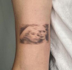 a person's arm with a tattoo on it that has an image of a hand