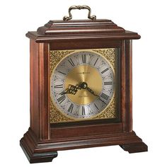 a wooden clock with roman numerals on the face and hands is shown against a white background