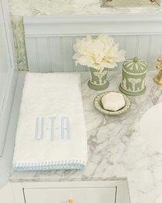 a bathroom with white and blue decor on the counter