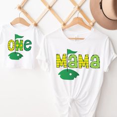 two t - shirts that say one mama and one baby are hanging on a rack