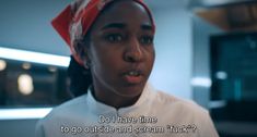 a woman with a red bandana on her head is talking to someone in the kitchen