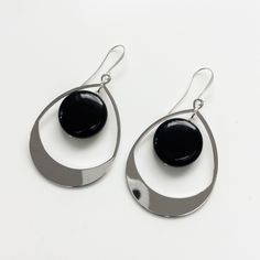 "Elegant large dangle earrings with a flat black obsidian stone, available in gold and silver finish. These elegant earrings are around 65mm long (2.5\") and finished with a gold or silver plated ear wire. Please note the display bust is not full size so the earrings look slightly bigger than they would in real life Free shipping These earrings come with a branded gift bag" Modern Teardrop Pendant Jewelry With Ear Wire, Modern Onyx Earrings With Black Enamel, Sleek Metal Drop Earrings, Elegant Black Enamel Hoop Earrings, Elegant Black Enamel Metal Earrings, Elegant Black Long Drop Chandelier Earrings, Nickel-free Black Teardrop Hoop Earrings, Black Nickel-free Teardrop Hoop Earrings, Black Teardrop Metal Jewelry