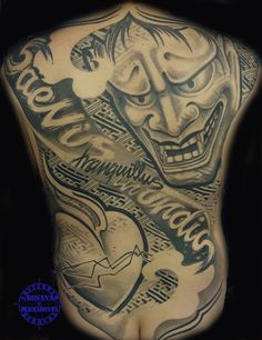 the back of a man with tattoos on his body and face in black ink,