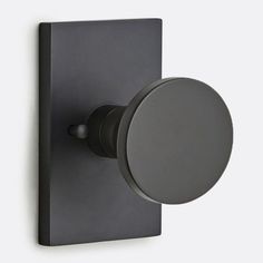 a black wall mounted robe hook with a round knob on the front and back of it