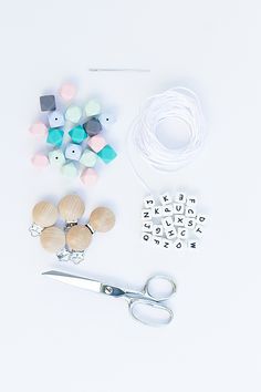 the supplies needed for making bead bracelets are laid out on a white surface