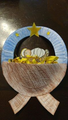 a paper plate with a baby in the middle and stars around it on a table