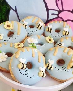 donuts decorated with honeybees and flowers on a plate