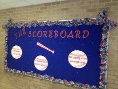 the scoreboard is decorated with plastic bottles and baseballs on it's side