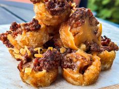 a pile of food sitting on top of a wooden table