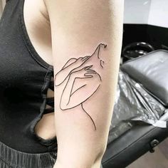 a woman's arm with a tattoo on it that is shaped like a hand