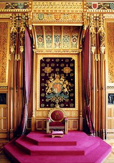 an elaborately decorated room with pink carpet and gold walls