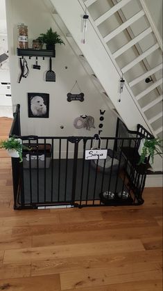 there is a baby gate in front of the stair railing that leads up to the second floor