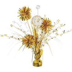 a vase filled with golden flowers and a clock