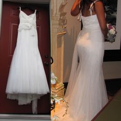 a woman in a white wedding dress standing next to a door