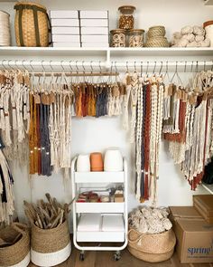 the shelves are filled with different types of yarn and other things in baskets on wheels