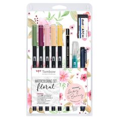 four different colored pens in a package on a white background with pink and yellow flowers