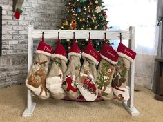 christmas stockings hanging on a rack in front of a fireplace