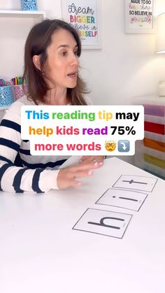 a woman sitting at a table with a sign that says help kids read 75 % more words