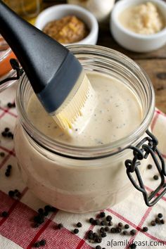 a jar filled with food and a brush in it