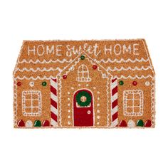 a gingerbread house door mat with the words home sweet home on it and candy canes