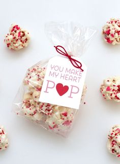 white and red sprinkles in a bag with a card saying you make my heart pop