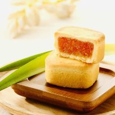 two pieces of food sitting on top of a wooden plate