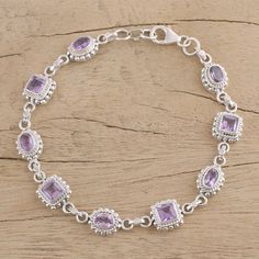 Lacy and feminine this bracelet comes from Bhavesh. It alternates oval and square-cut amethyst each surrounded by an an argent halo. Bhavesh presents a fresh new interpretation of traditional design. .925 Sterling silver Bracelet Design For Women, Bali Silver Jewelry, Buy Wholesale Jewelry, Fake Jewelry, Bali Silver, Stylish Bracelet, Amethyst Bracelet, Silver Jewelry Handmade, Bracelet Handmade