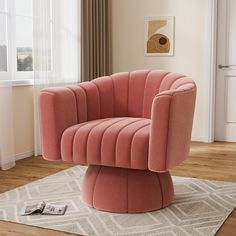 a pink chair sitting on top of a white rug