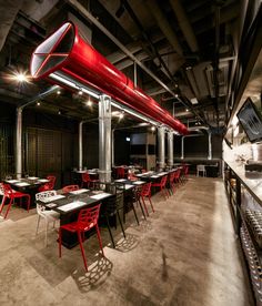 an empty restaurant with tables and red chairs