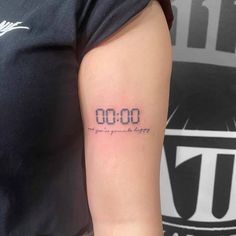 a woman with a tattoo on her arm that reads 000 and has the date