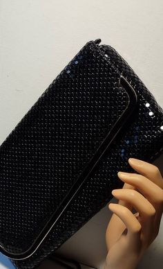 This is a beautiful quality clutch that converts to a strap handle. This vintage black mesh sequin evening bag has an envelope closure. This evening bag is in excellent condition. Nice size for all your needs. Has a black mesh chain strap that hides inside when not needed. Nice size zipper pocket inside. Condition: Excellent. The black sequin mesh sparkles and shines highlighted by the gold trim at the flap, clasp, and findings. Tagged: MADE HONG KONG. A terrific modern look that's always in sty Handbag Straps, Acrylic Beads, Black Sequins, Black Mesh, Fold Over, Gold Trim, Chain Strap, Vintage Pink