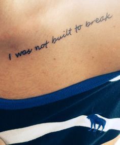 a woman with a tattoo on her chest saying i may not built to break,