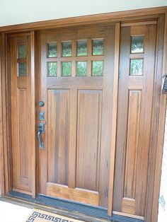 the front door is made of wood and has two sidelights on each side,