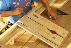 a man working with wood on a table