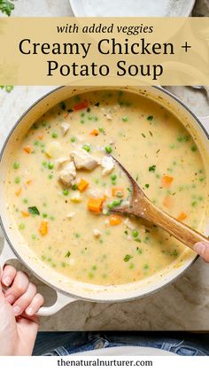 creamy chicken and potato soup in a pot with a wooden spoon