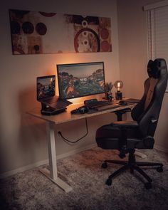 a chair that is sitting in front of a desk with a monitor and laptop on it