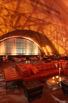 a living room filled with lots of red couches