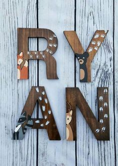 wooden letters that spell out the word farm with animals and deers painted on them