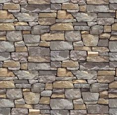 a stone wall that is made up of several different types of stones and has brown, tan