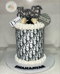 a black and white cake with the number fifty five on it's top tier