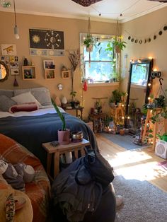 a bedroom with lots of plants and decorations on the walls, windows, and rugs