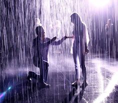 two people standing in the rain holding hands