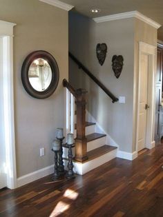 the stairs in this house are made of wood and have heart shaped mirrors on them