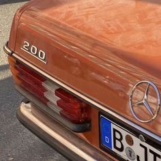 the back end of an orange mercedes benz